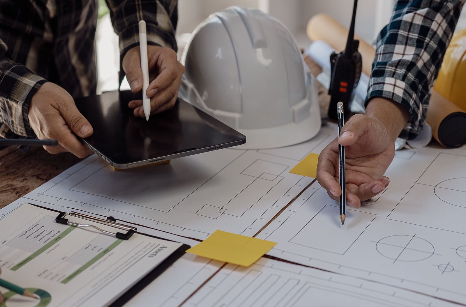 Project and commercial team reviewing drawings, programme and cost information