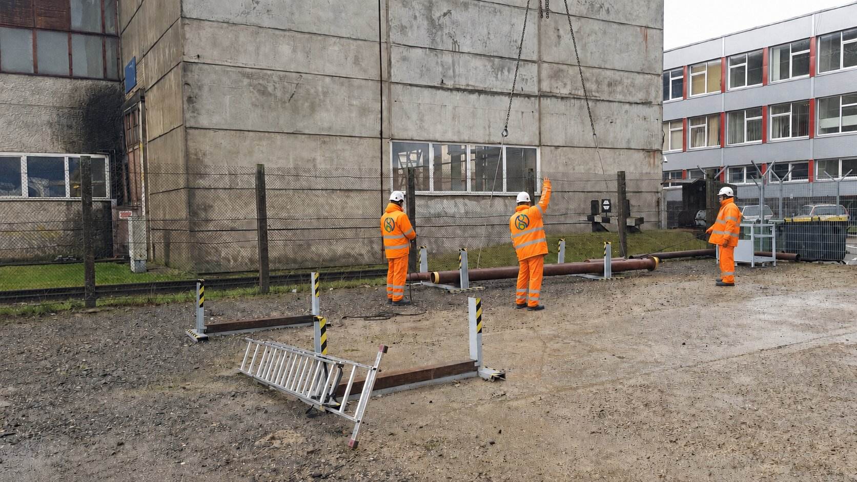 UNIT8D operatives guiding a pipe lift on an infrastructure site
