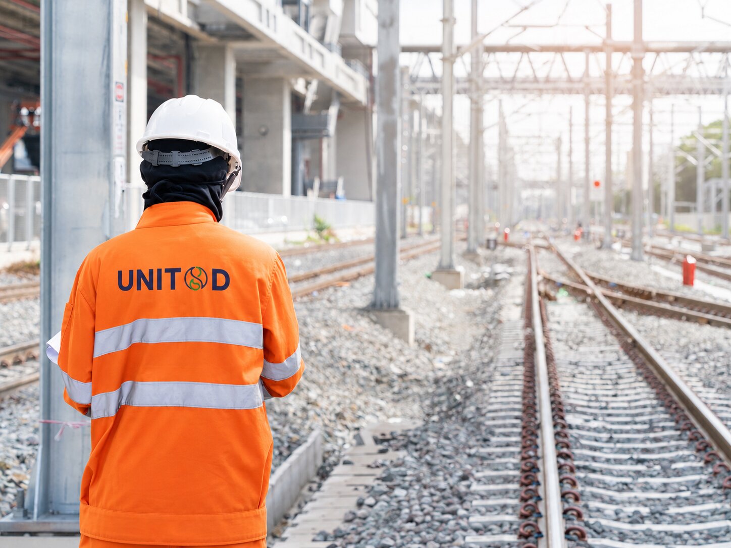 UNIT8D operative looking along the tracks at a rail depot