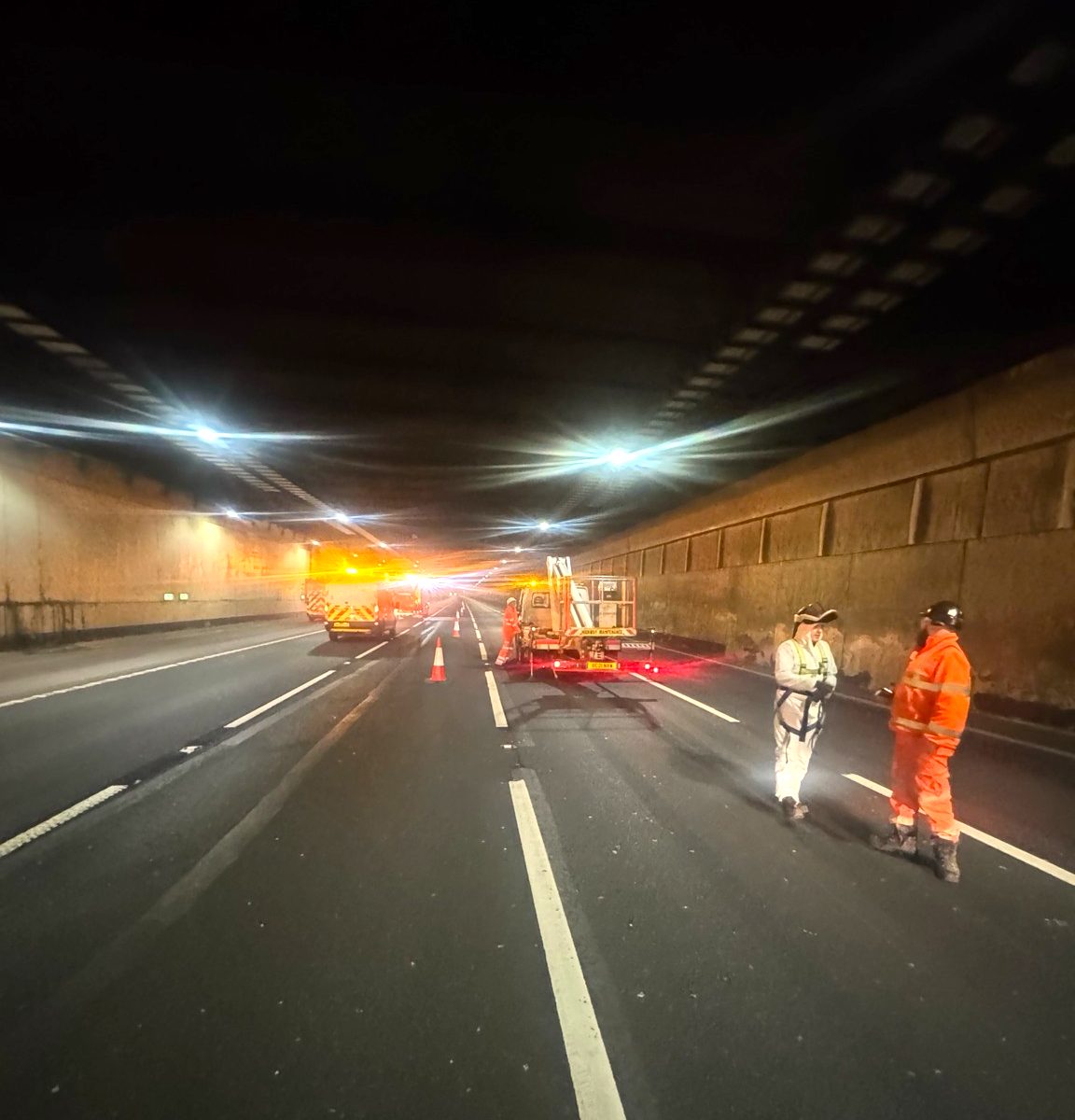 Night works under lights inside a road tunnel